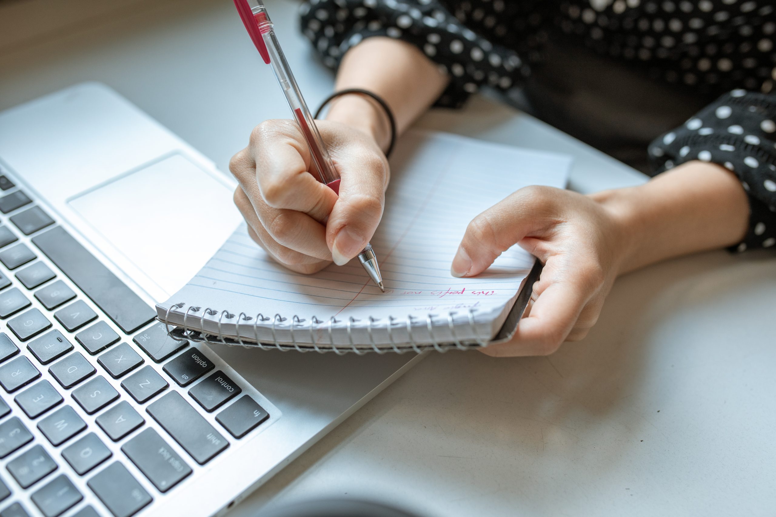 Person writing on white paper